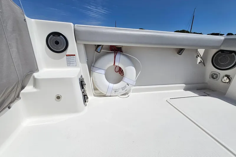 T-time Yacht Photos Pics 2006 Tiara 3200 Open boat deck with life preserver and speakers under clear sky.