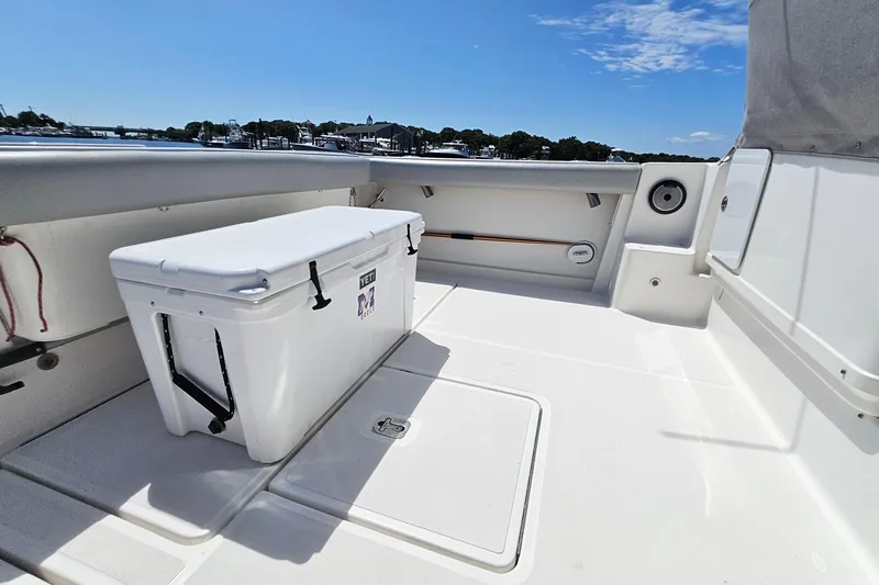T-time Yacht Photos Pics 2006 Tiara 3200 Open boat deck with Yeti cooler, under clear blue sky.