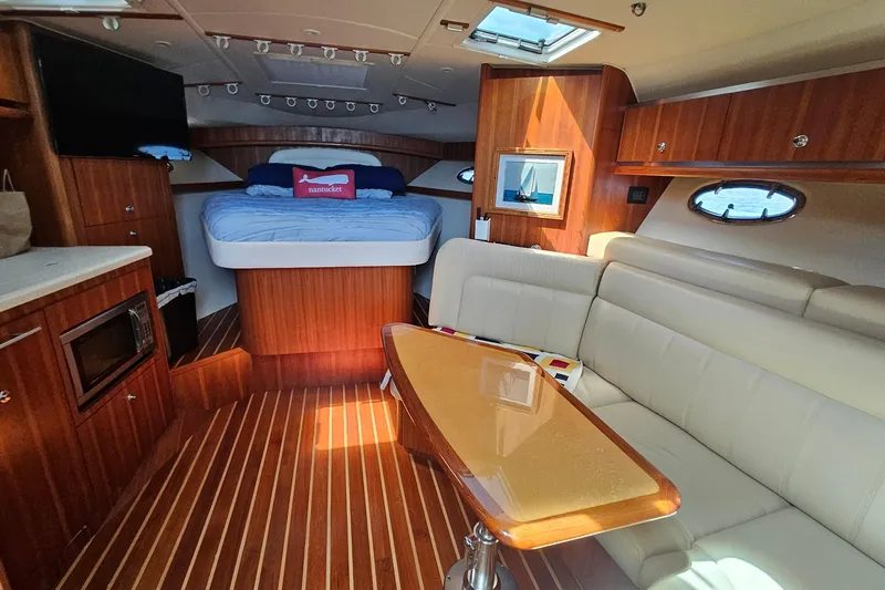 T-time Yacht Photos Pics Luxurious interior of a 2006 Tiara 3200 Open yacht with cozy seating and elegant wood finishes.