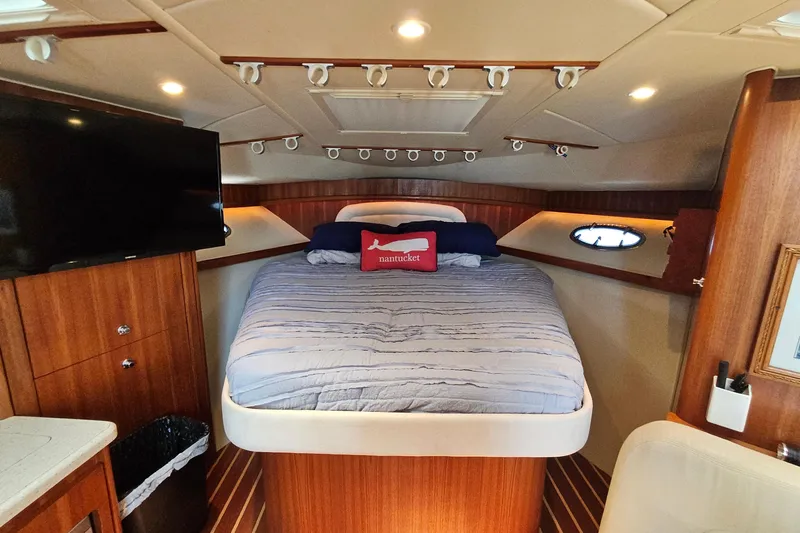 T-time Yacht Photos Pics Luxurious cabin interior of a 2006 Tiara 3200 Open yacht with cozy bed and modern amenities.