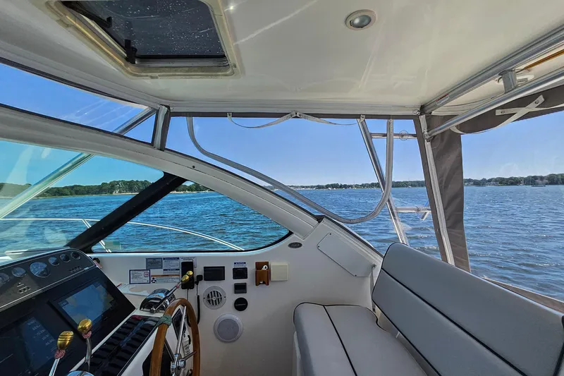 T-time Yacht Photos Pics Interior view of 2006 Tiara 3200 Open yacht with scenic water backdrop.