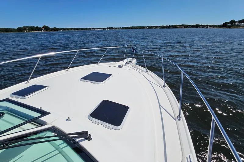 T-time Yacht Photos Pics 2006 Tiara 3200 Open yacht cruising on a sunny day, showcasing sleek deck design.