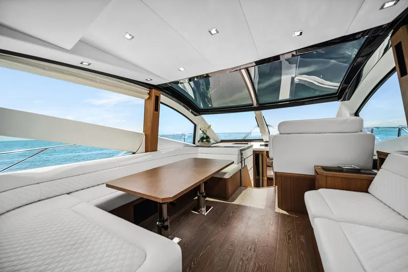  Yacht Photos Pics Luxurious interior of 2019 Galeon 560 Sky yacht with panoramic windows and elegant seating.