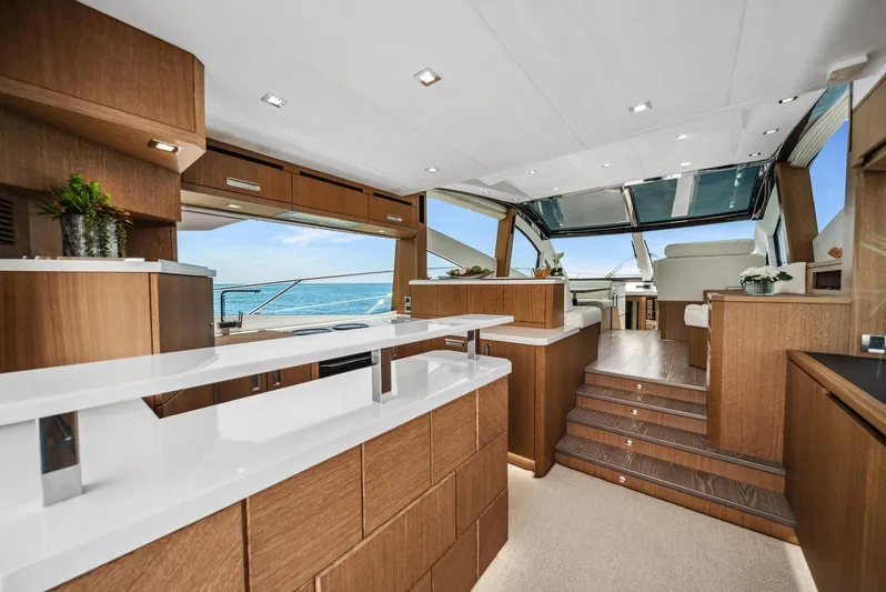  Yacht Photos Pics Luxurious interior of 2019 Galeon 560 Sky yacht with modern wood finishes and ocean view.