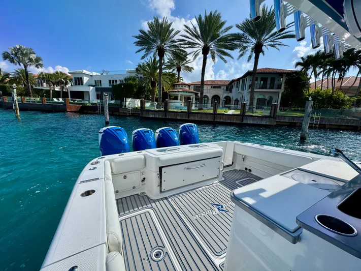  Yacht Photos Pics 2019 HCB 42 Siesta boat docked near luxury waterfront homes and palm trees.
