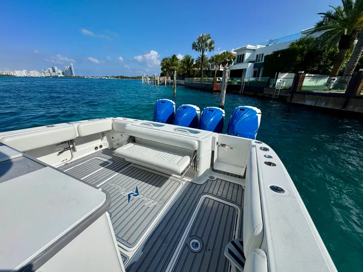  Yacht Photos Pics 2019 HCB 42 Siesta boat with four engines, docked near waterfront homes.