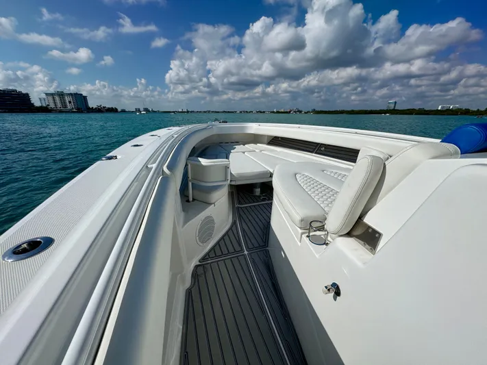  Yacht Photos Pics 2019 HCB 42 Siesta boat with luxurious seating on calm waters under a partly cloudy sky.