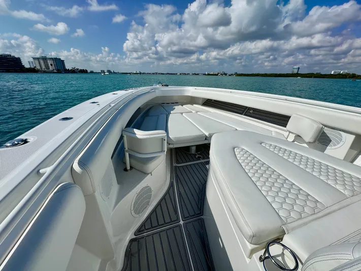  Yacht Photos Pics 2019 HCB 42 Siesta boat with luxurious seating on calm waters under a cloudy sky.