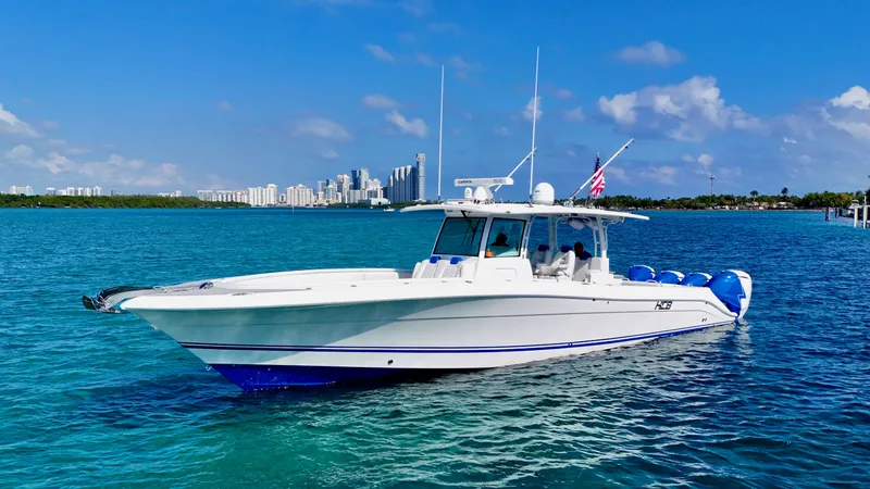  Yacht Photos Pics 2019 HCB 42 Siesta boat cruising on blue water with city skyline in background.
