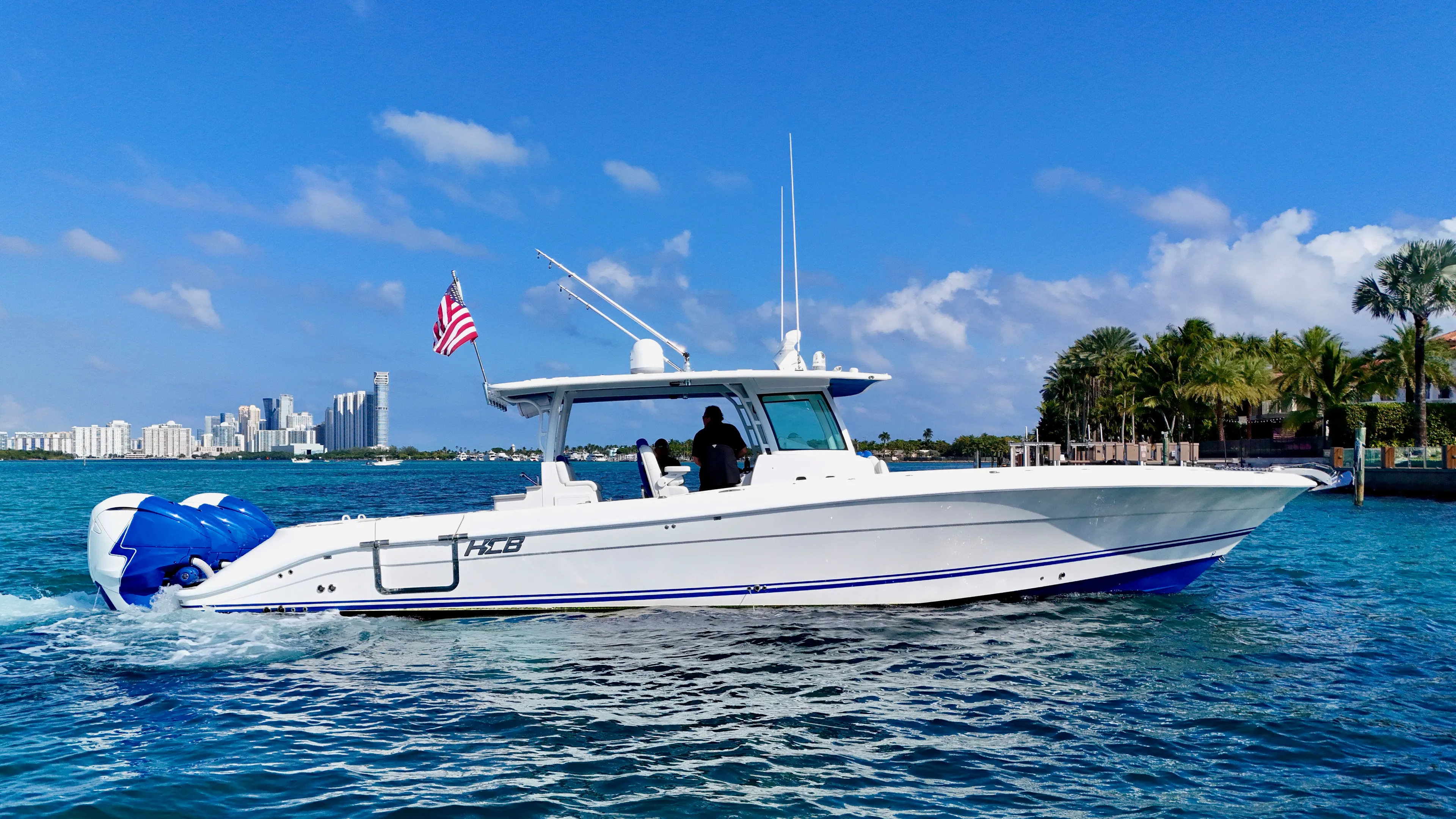  Yacht Photos Pics 2019 HCB 42 Siesta boat cruising on blue water near a city skyline.