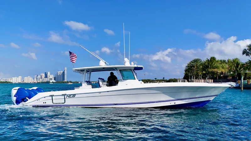  Yacht Photos Pics 2019 HCB 42 Siesta boat cruising on blue water with city skyline in background.