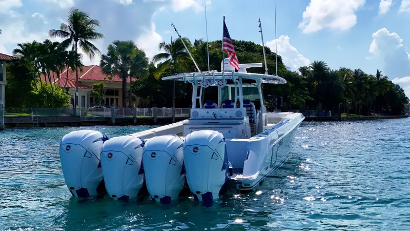  Yacht Photos Pics 2019 HCB 42 Siesta boat with four engines on a sunny day, near waterfront homes.