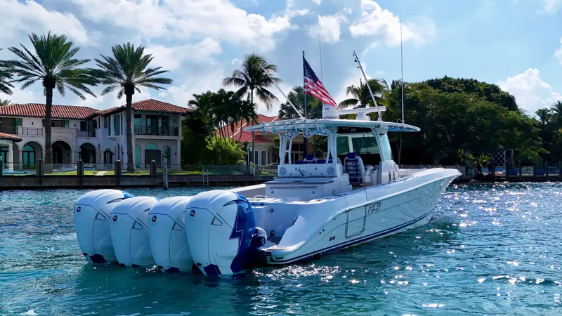  Yacht Photos Pics 2019 HCB 42 Siesta boat with multiple engines on a sunny waterfront.