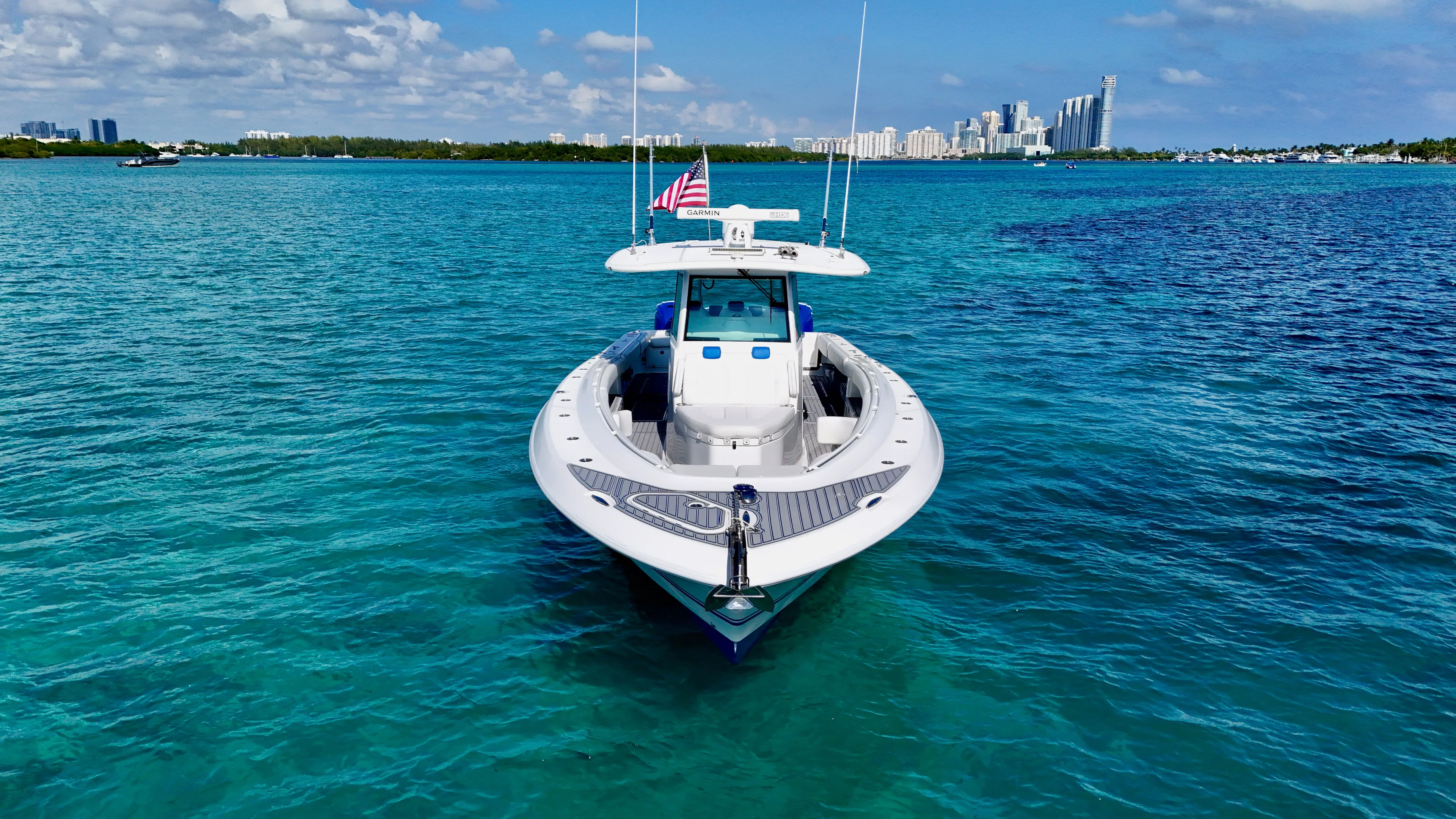  Yacht Photos Pics 2019 HCB 42 Siesta boat on clear blue water with city skyline in background.