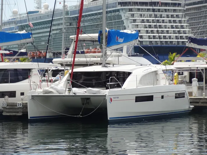 Blue Tiger Yacht Photos Pics 2021 Leopard 40 catamaran docked at marina with cruise ship in background.