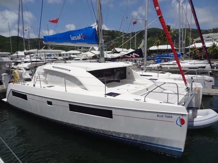 Blue Tiger Yacht Photos Pics 2021 Leopard 40 catamaran docked at marina, featuring sleek design and spacious deck.