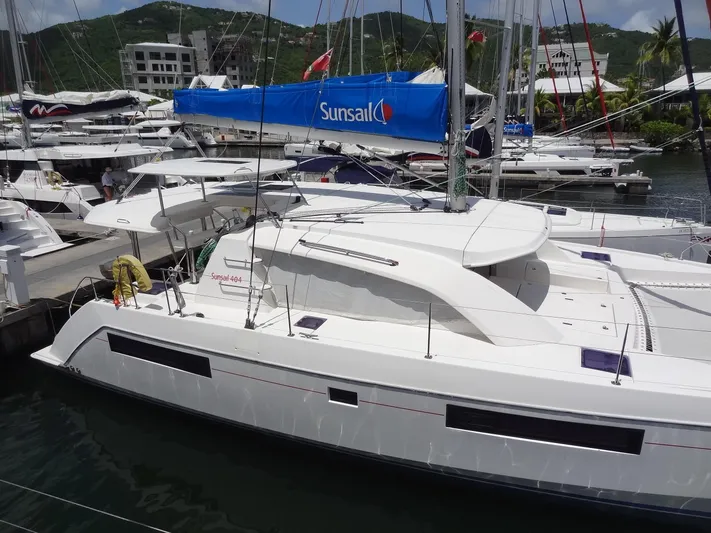 Blue Tiger Yacht Photos Pics 2021 Leopard 40 catamaran docked in marina, surrounded by other boats.