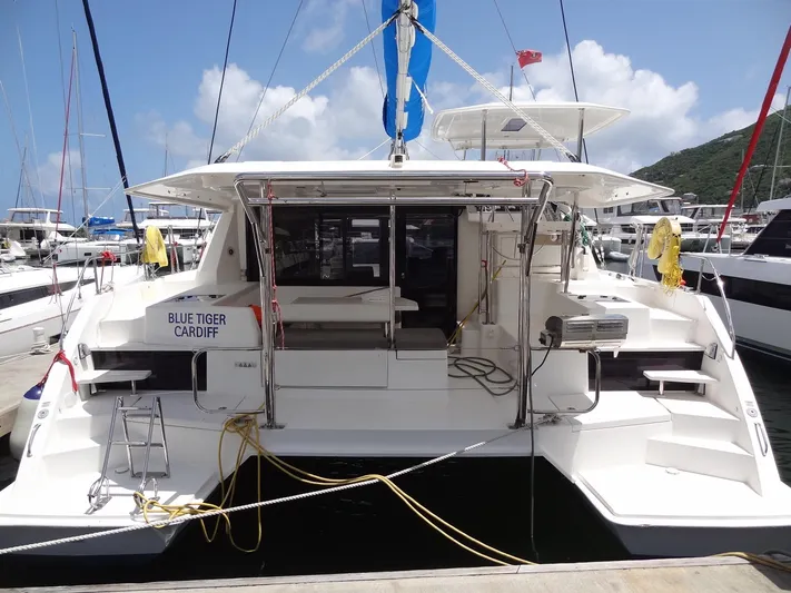 Blue Tiger Yacht Photos Pics 2021 Leopard 40 catamaran docked at marina, rear view with clear sky.