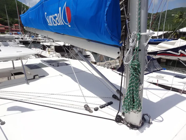 Blue Tiger Yacht Photos Pics 2021 Leopard 40 catamaran with blue sail cover, docked in a marina.