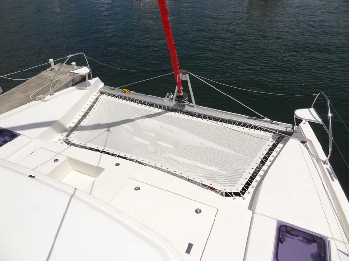 Blue Tiger Yacht Photos Pics 2021 Leopard 40 catamaran with netting on deck, docked by calm water.