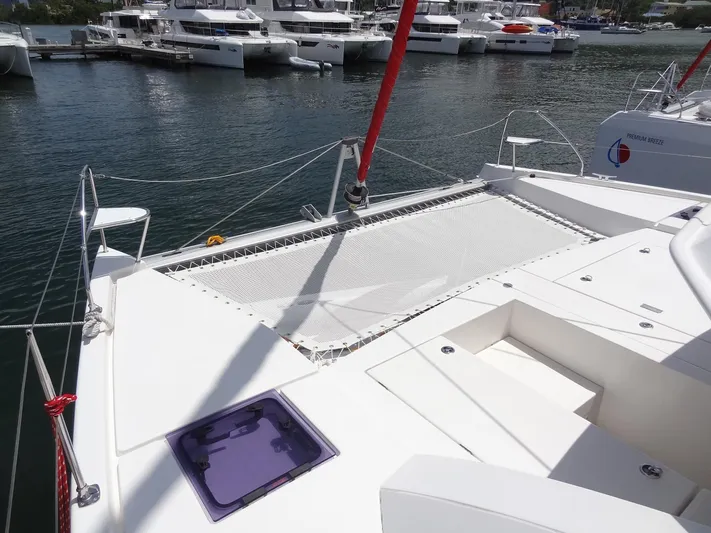 Blue Tiger Yacht Photos Pics Leopard 40 catamaran deck with netting, docked in a marina, 2021 model.