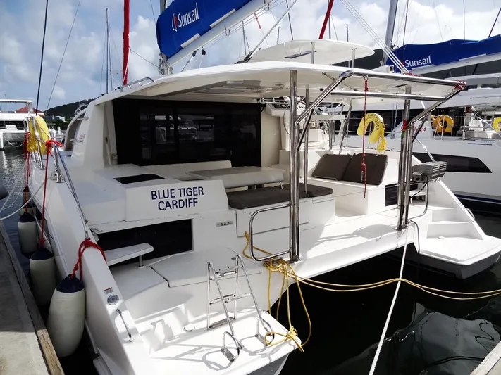 Blue Tiger Yacht Photos Pics 2021 Leopard 40 catamaran docked, featuring spacious deck and seating area.