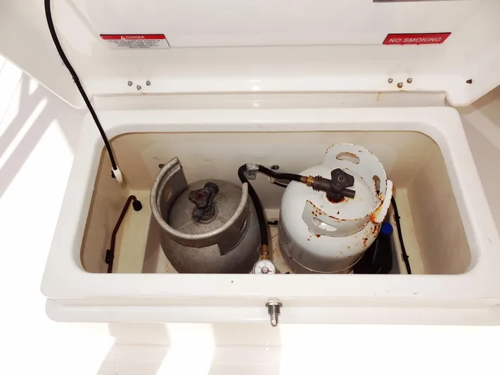 Blue Tiger Yacht Photos Pics Propane storage compartment on a 2021 Leopard 40 boat, featuring two gas cylinders.