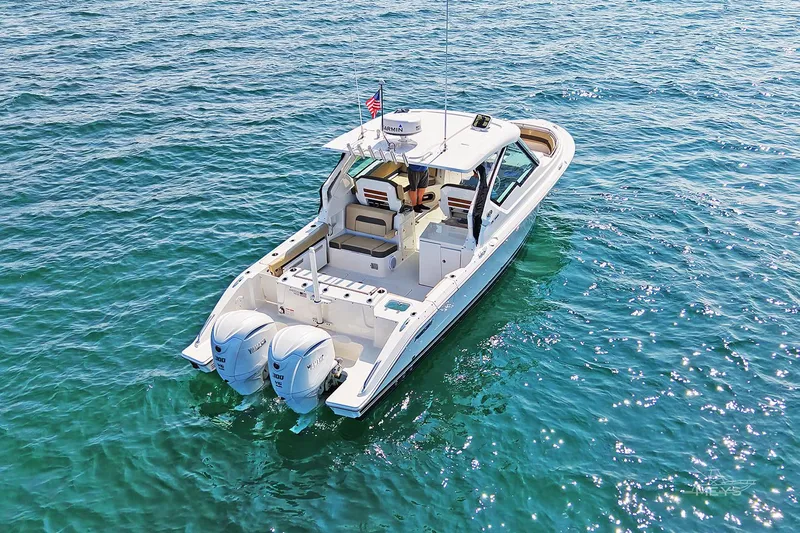 Pathfinder Yacht Photos Pics 2021 Pursuit DC 326 Dual Console boat on clear blue water.