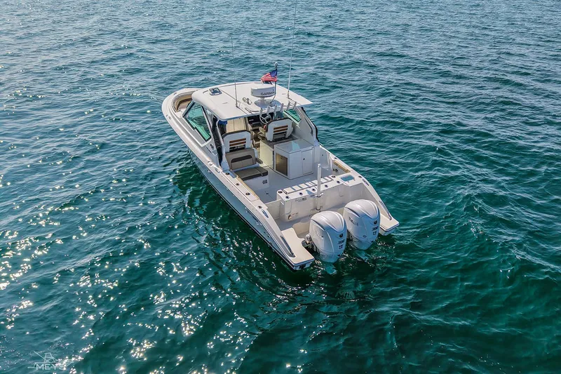 Pathfinder Yacht Photos Pics 2021 Pursuit DC 326 Dual Console boat on open water, featuring twin engines.