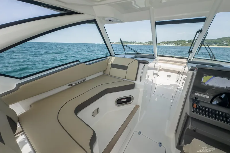 Pathfinder Yacht Photos Pics 2021 Pursuit DC 326 Dual Console interior with ocean view and modern dashboard.