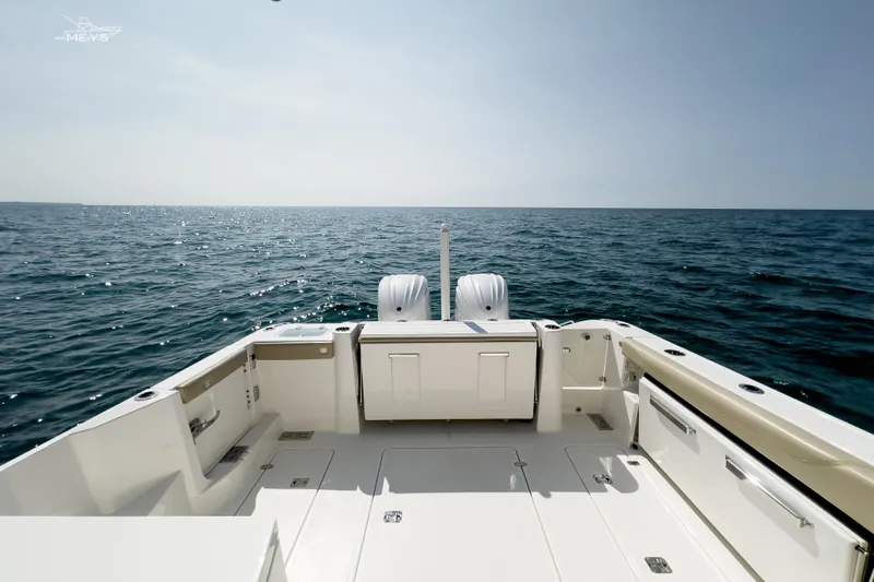 Pathfinder Yacht Photos Pics 2021 Pursuit DC 326 Dual Console boat on open sea, showcasing spacious deck and twin engines.