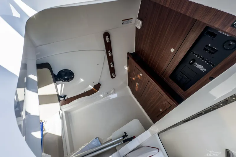 Pathfinder Yacht Photos Pics 2021 Pursuit DC 326 Dual Console interior with wood paneling and control panel.