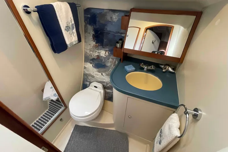 La Veda Yacht Photos Pics 2003 Hunter 426 Deck Salon bathroom with modern fixtures and nautical decor.