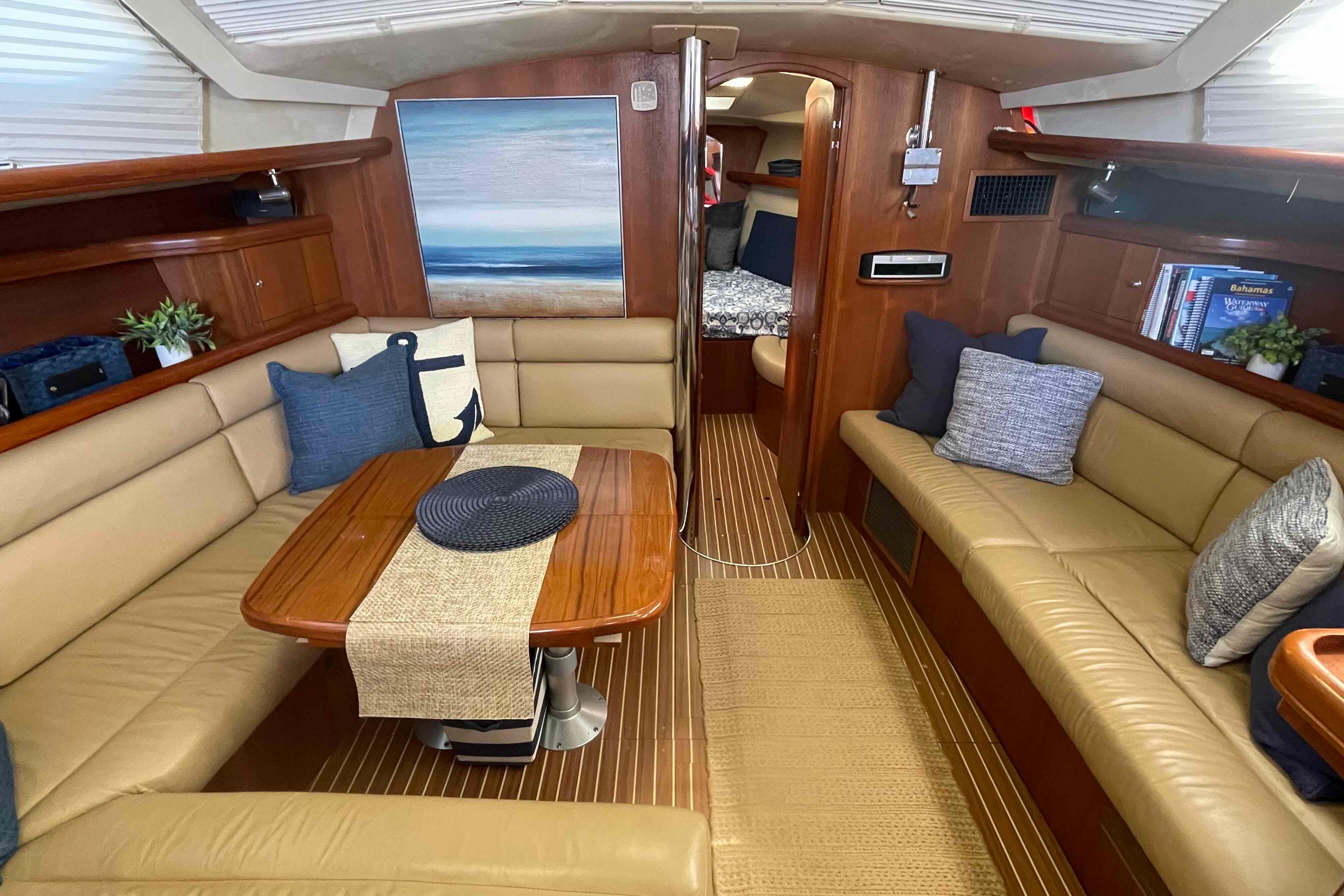 Luxurious interior of 2003 Hunter 426 Deck Salon yacht with cozy seating and elegant decor.
