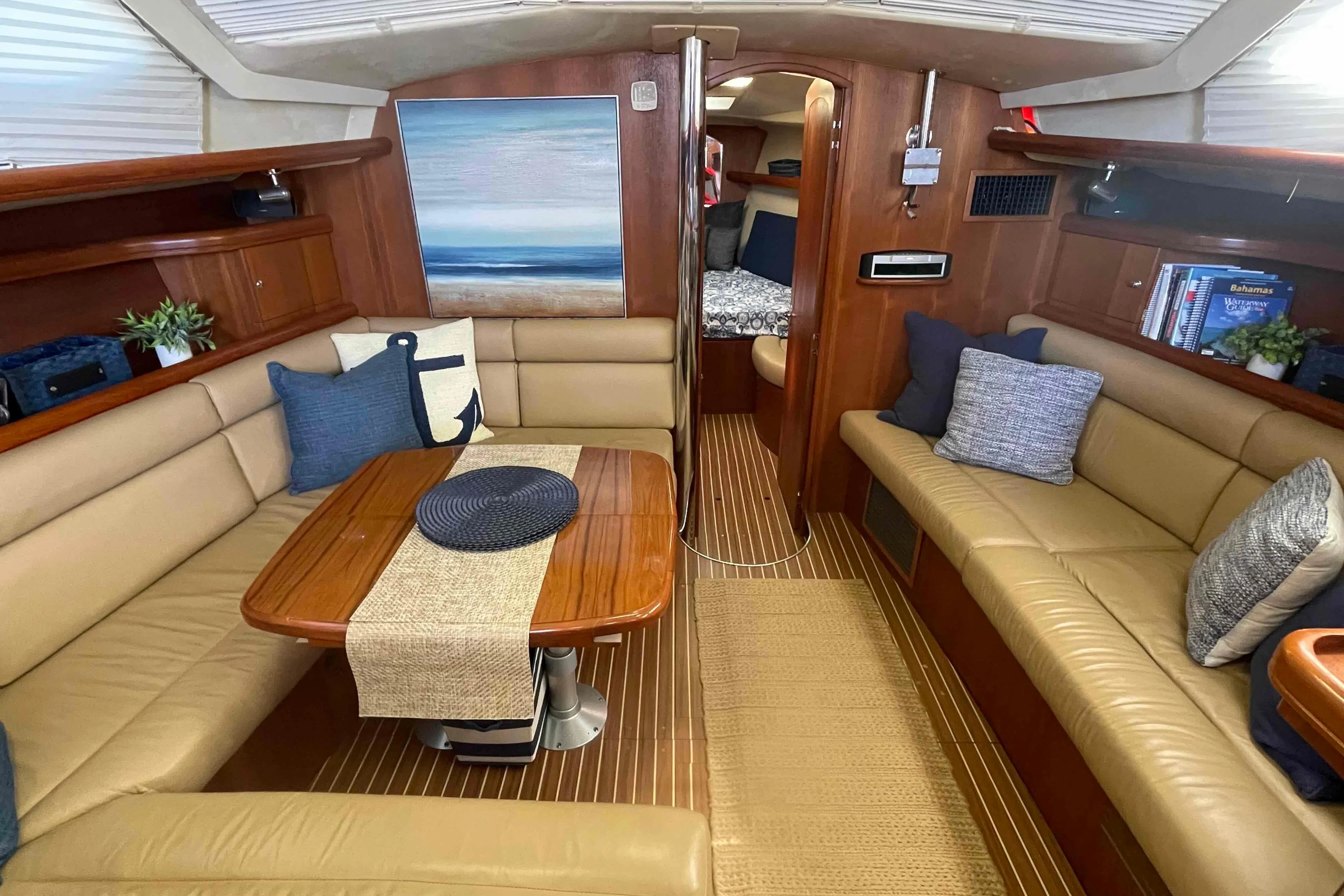 Luxurious interior of 2003 Hunter 426 Deck Salon yacht with cozy seating and elegant decor.