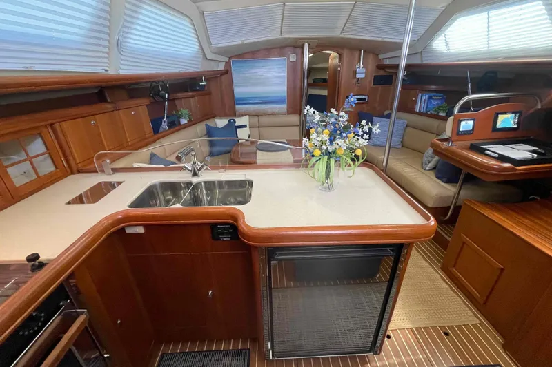 La Veda Yacht Photos Pics Luxurious interior of 2003 Hunter 426 Deck Salon with modern kitchen and cozy seating area.