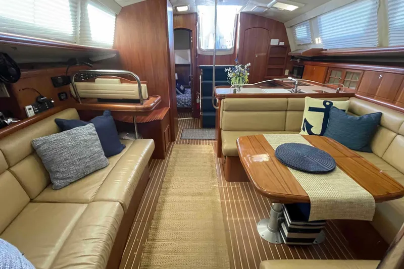 La Veda Yacht Photos Pics Luxurious interior of 2003 Hunter 426 Deck Salon yacht with elegant seating and dining area.