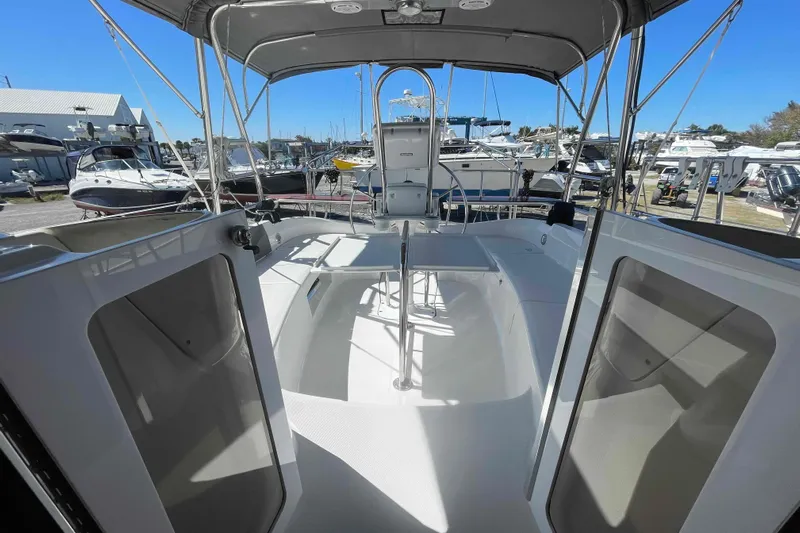 La Veda Yacht Photos Pics 2003 Hunter 426 Deck Salon sailboat cockpit with canopy, docked among other boats.