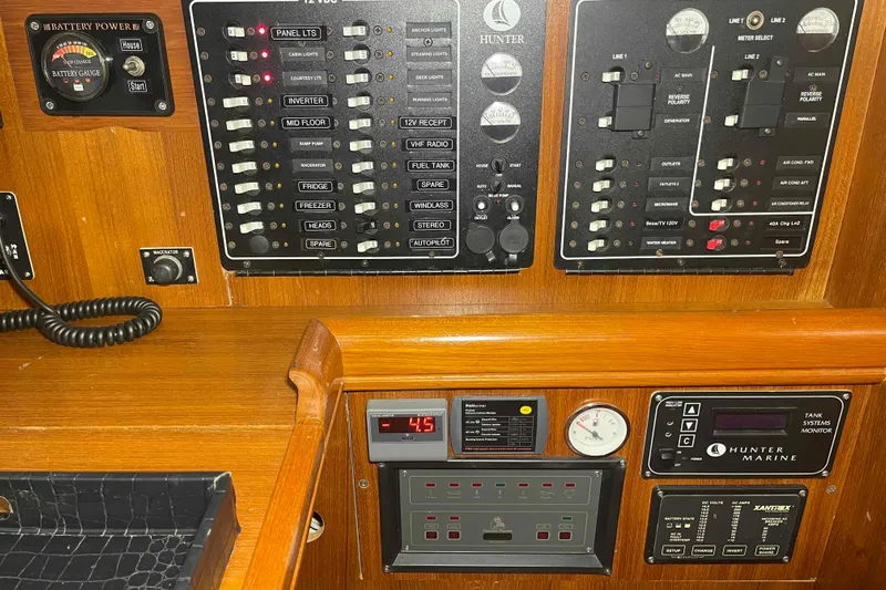 La Veda Yacht Photos Pics Control panel of a 2003 Hunter 426 Deck Salon yacht with various switches and gauges.