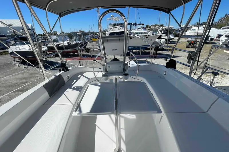 La Veda Yacht Photos Pics 2003 Hunter 426 Deck Salon sailboat cockpit with marina view, showcasing sleek design and spacious seating.