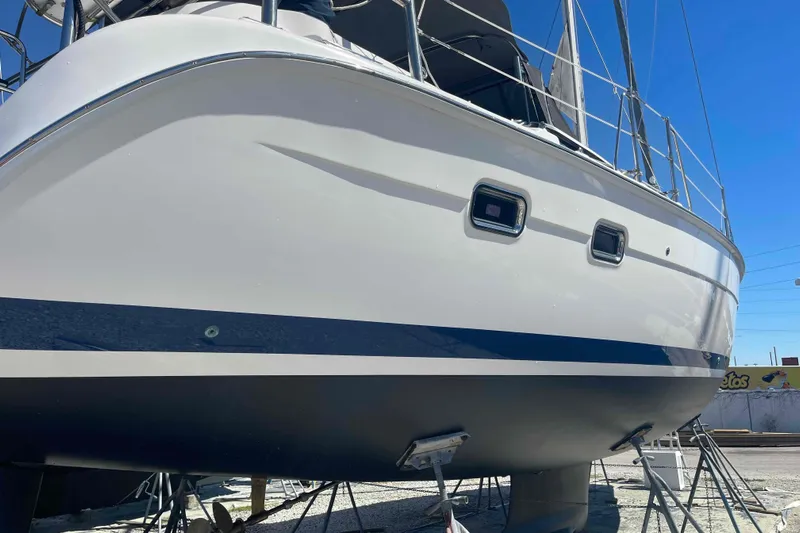 La Veda Yacht Photos Pics 2003 Hunter 426 Deck Salon sailboat on dry dock, side view under clear blue sky.