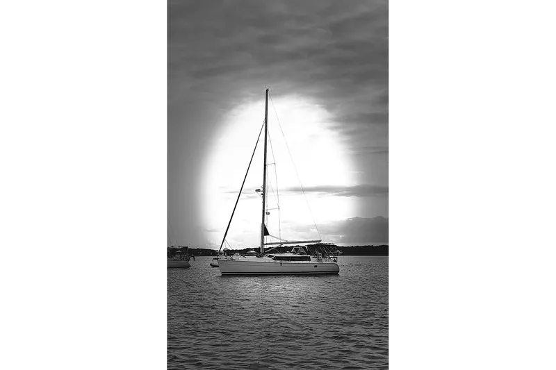 La Veda Yacht Photos Pics Sailboat Hunter 426 Deck Salon 2003 on calm water at sunset, black and white.