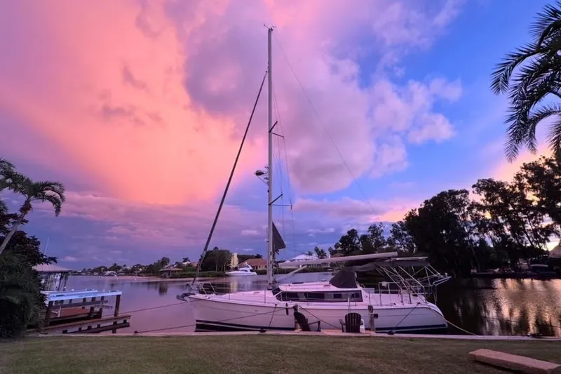 La Veda Yacht Photos Pics Hunter 426 Deck Salon 2003 sailboat docked at sunset with vibrant sky.
