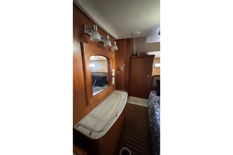 La Veda Yacht Photos Pics Interior of 2003 Hunter 426 Deck Salon with wooden cabinetry and mirror.