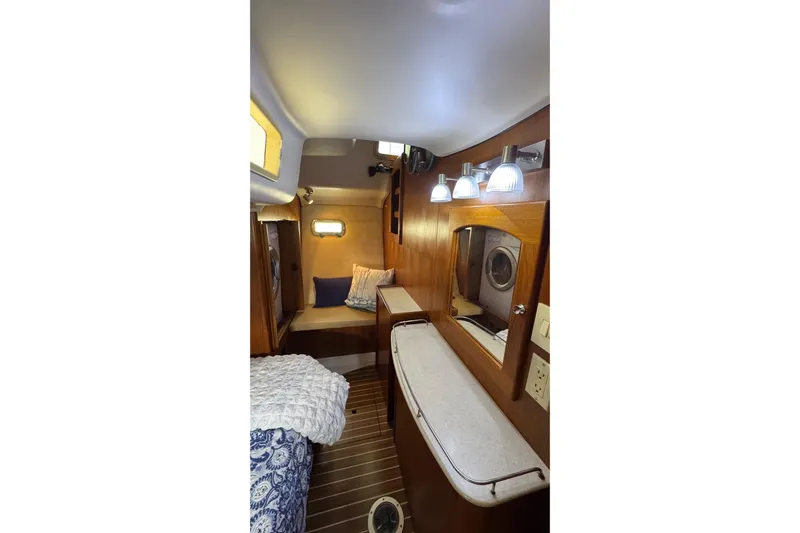 La Veda Yacht Photos Pics Interior of 2003 Hunter 426 Deck Salon, featuring cozy cabin with wood accents and lighting.