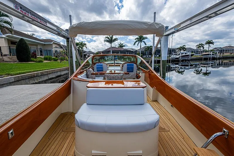 Mareca Yacht Photos Pics 2004 Hinckley Talaria 29 R boat with elegant wooden interior docked by waterfront homes.