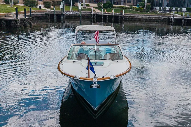Mareca Yacht Photos Pics 2004 Hinckley Talaria 29 R boat on calm water, front view with flags.