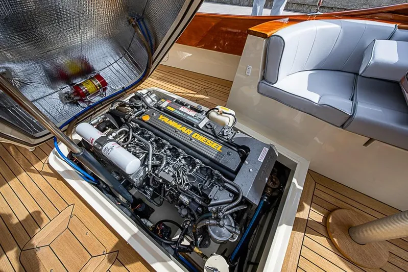 Mareca Yacht Photos Pics Engine compartment of 2004 Hinckley Talaria 29 R with Yanmar diesel engine and seating area.