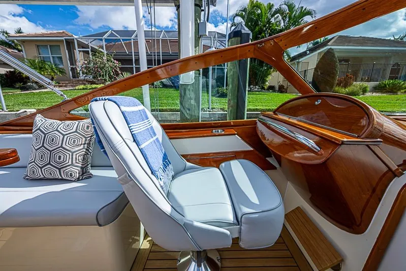 Mareca Yacht Photos Pics 2004 Hinckley Talaria 29 R boat interior with wooden accents and cushioned seating.