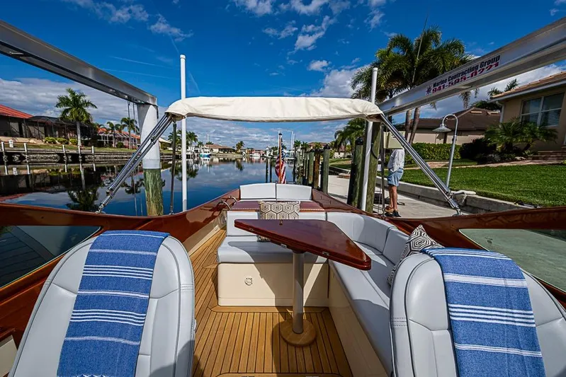 Mareca Yacht Photos Pics 2004 Hinckley Talaria 29 R boat docked, featuring elegant seating and wooden accents under a clear sky.